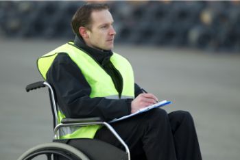 Man in a high vis jacket working, he is in a wheelchair
