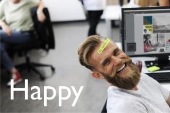 Man laughing with sticky note saying "Happy" on his head