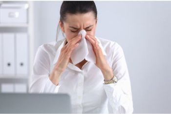 Woman working at a laptop her nose