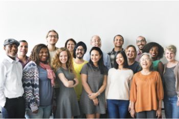 Diverse group of people stood together smiling