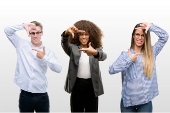 Three employees gesturing with their hands to show perspective