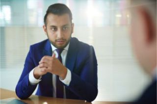 An employee looks pensive in a return to work interview