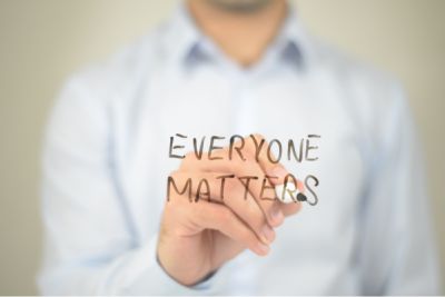 Man writing Everyone Matters clear screen