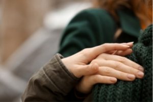 Womans hand on a friends should giving comfort